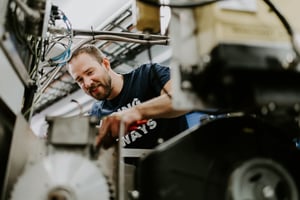 Simon working on the E Compressor, a complete breathing air system designed for safety, quality, and efficiency.